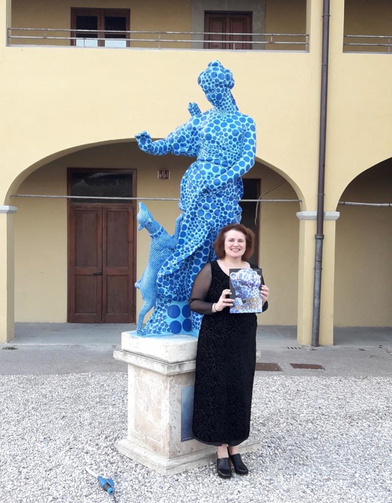 DR. MELANIE ZEFFERINO, Chief Curator, Florence Biennale, Presenting the GOLD LIST Special Edition of The International Art Market Magazine at Florence Biennale 2017 On the Background: “Diana”, Statue with foundation, 278x85x55cm