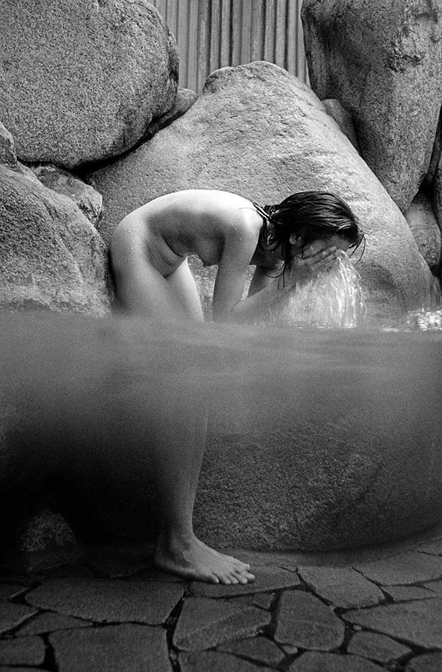 A bather in the iron-rich carbonated sodium chloride water at the Goshobo Ryokan in Arima in Hyogo Prefecture.  
Mark Edward Harris @All rights reserved.  