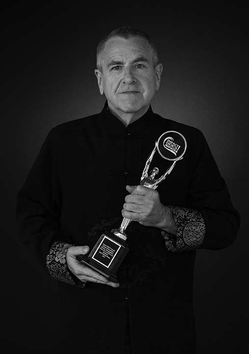 Mark Edward Harris holds his latest award, this one for being a producer on the documentary, From Hell to Hollywood, about Pulitzer Prize-winning photographer Nick Ut. 