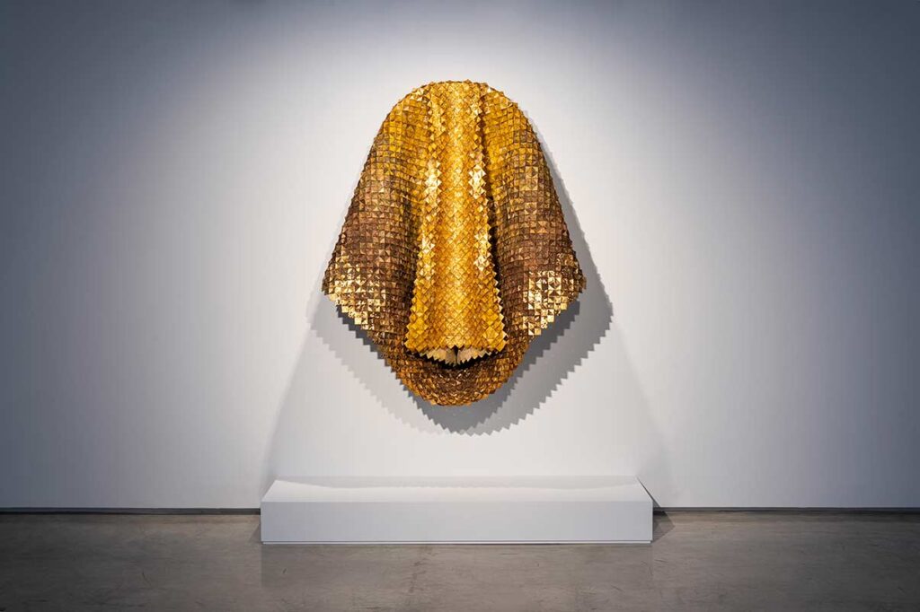 Exhibition view.
The centerpiece at the exhibition is a collaborative work titled The Phoenix Rebirth, created using handmade paper produced from palm tree fibres gathered from the Oasis of Gabès. This paper was developed in Hamouda’s studio and laboratory, where Swinburn joined him in the making process during several research visits to Gabès.
The final piece, for which Swinburn wove the handmade paper, integrates natural pigments, palm leaves, and is engraved with knitting and crochet cotton cloths crafted by local women artisans, as well as gold leaf.
Catalina Swinburn & Mohamed Amine Hamouda © Selma Feriani Gallery