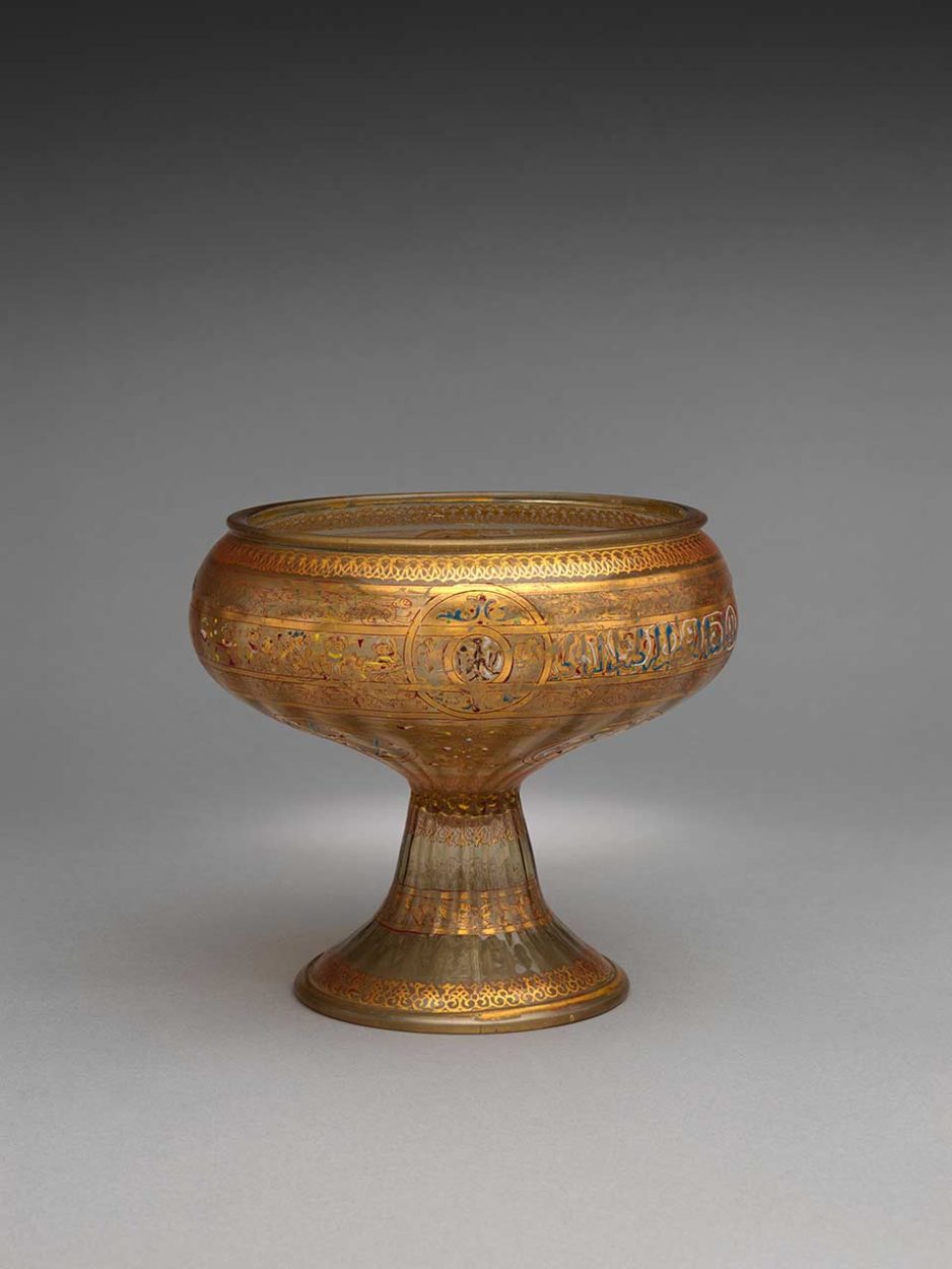 Orientalism and Design;
Footed Bowl with Eagle Emblem, mid-13th century
Glass: dip-molded, blown, enameled, and gilded
H. 7 3/16 in. (18.3 cm) Max. Diam. 8 in. (20.3 cm)
Diam. of Base: 5 in. (12.7 cm)
Edward C. Moore Collection, Bequest of Edward C. Moore, 1891
© The MET